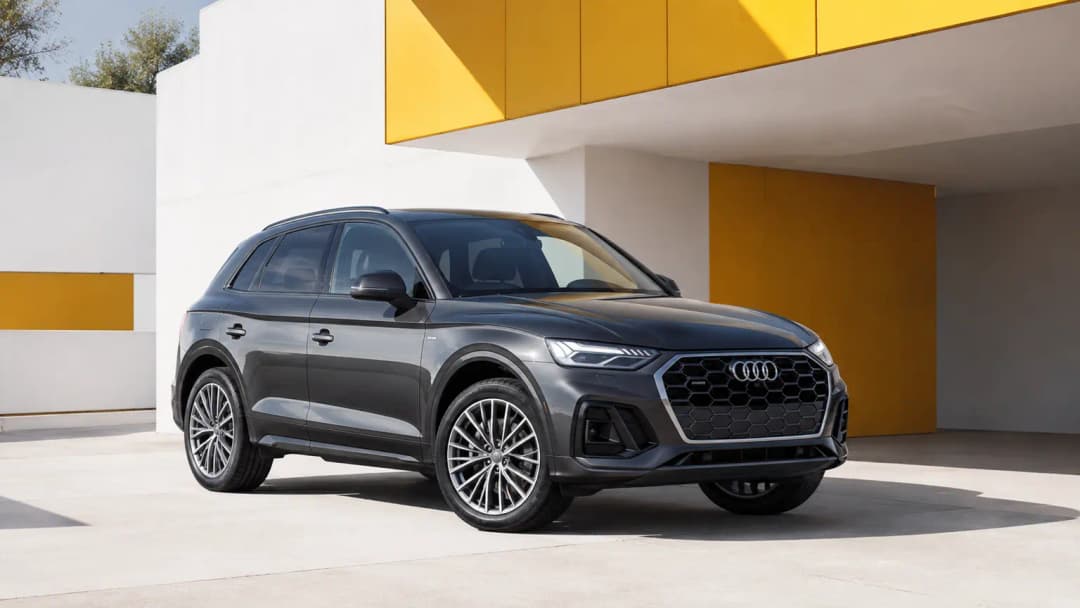 Audi Q5 parked beside contemporary architecture